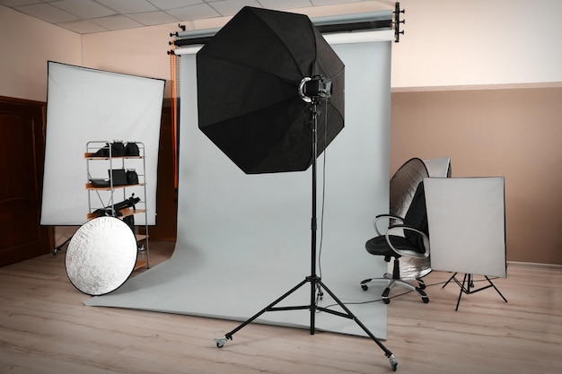 Empty photo studio with lighting equipment