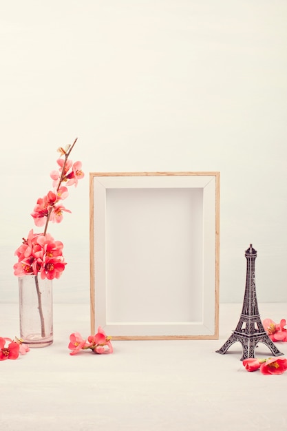 empty picture frame and pink spring flowers.