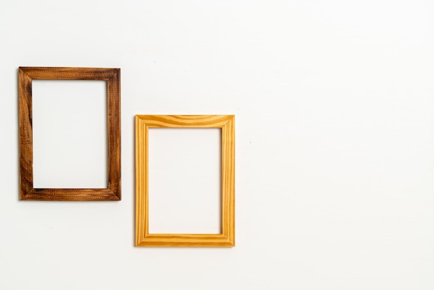 Empty picture frame on white wall background