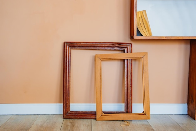 Empty picture frames against the wall baguette workshop materials and accessories for creativity and drawing