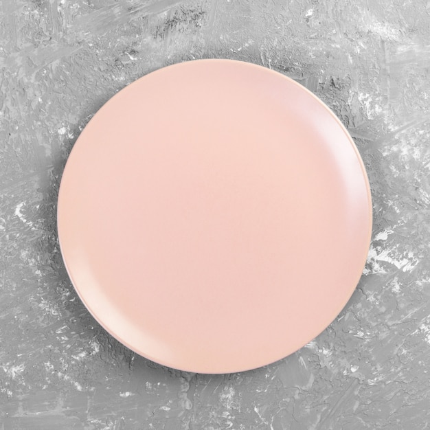 Empty pink or coral round plate