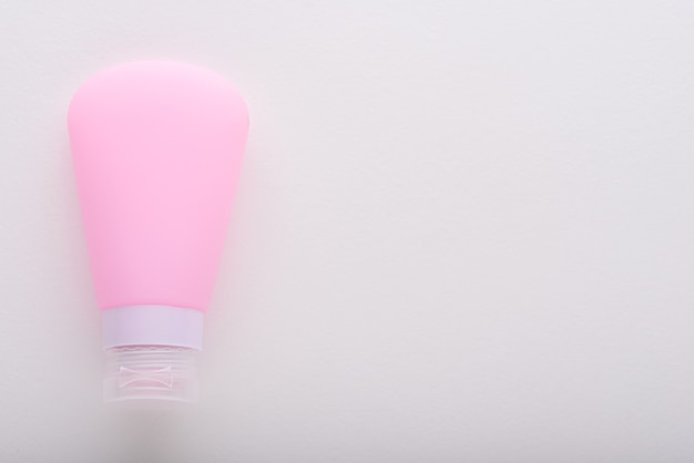 Empty pink cosmetic cream packaging on white background for branding with copy space