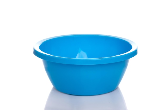 Empty plastic blue bowl on white background