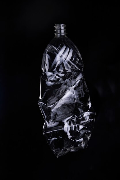 empty plastic bottle for recycling over dark background