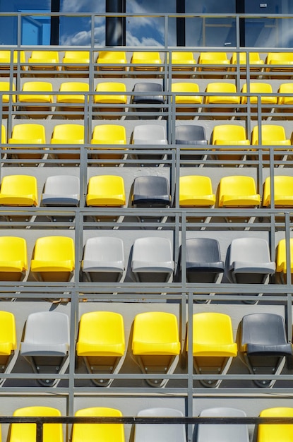 Empty plastic colored seats in stadium without spectators close-up water arena