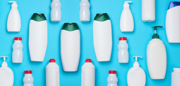 Empty plastic white bottles for cosmetics and other liquid substances on a blue background blank