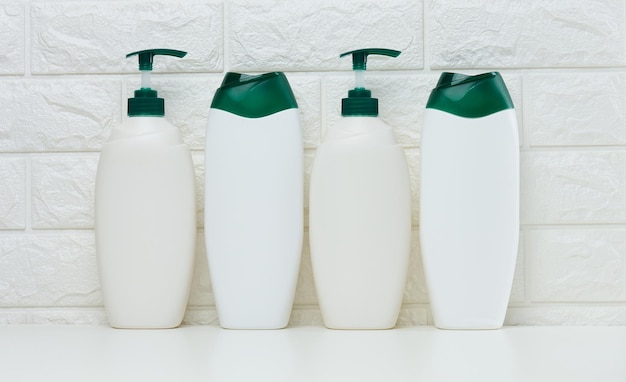 Empty plastic white bottles for cosmetics and other liquid substances on a white background