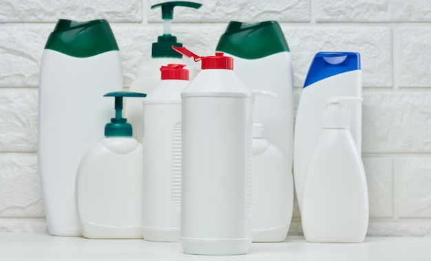 Empty plastic white bottles for cosmetics and other liquid substances on a white background