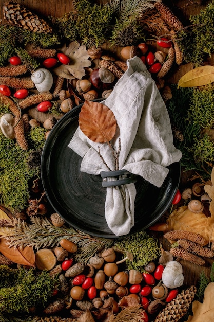 Empty plate over ambiance magic autumnal forest background