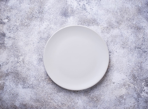 Empty plate on concrete table