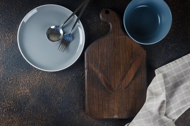 Empty plate cutlery for dinner or lunch eat dark table top view Lunch table place setting in dark