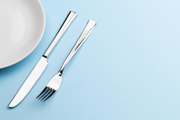 Empty plate fork and knife