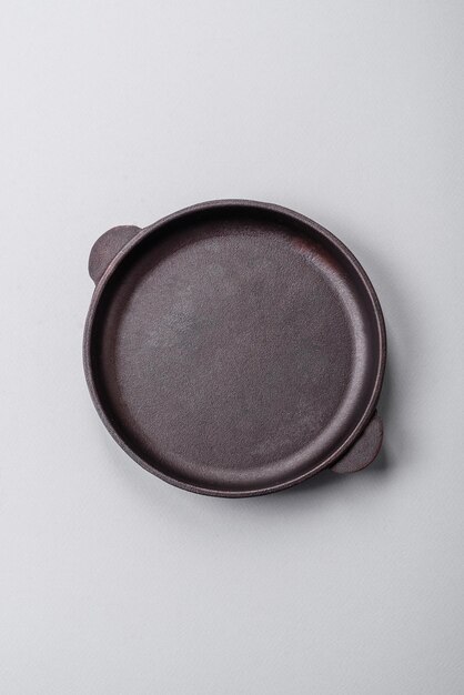 An empty plate on a gray concrete background with copy space