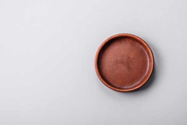 An empty plate on a gray concrete background with copy space