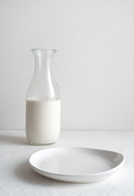 Empty plate and a jug of milk