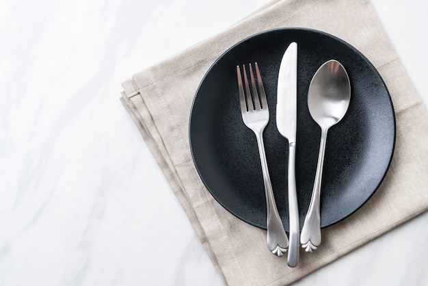 empty plate spoon fork and knife