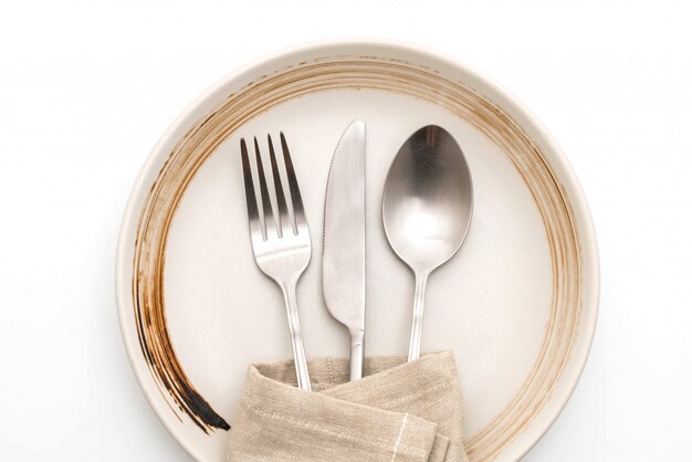 empty plate spoon fork and knife