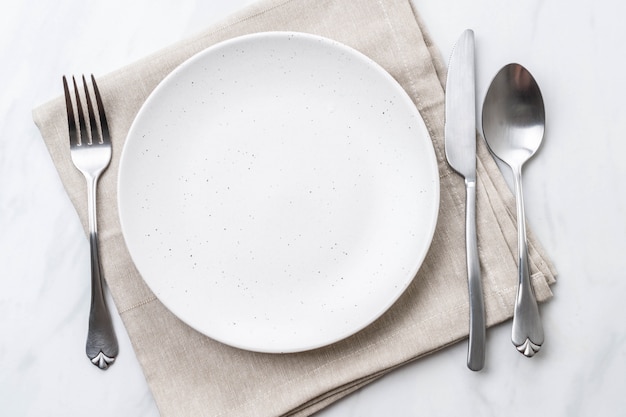 empty plate spoon fork and knife