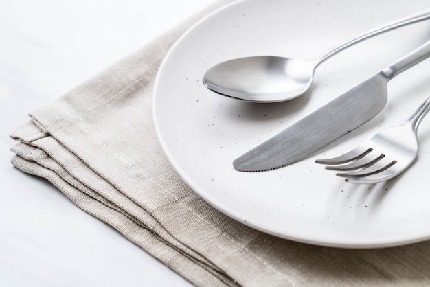 empty plate spoon fork and knife