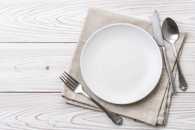 empty plate spoon fork and knife