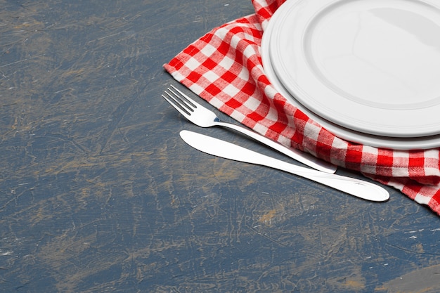 Empty plate and towel over wooden surface table