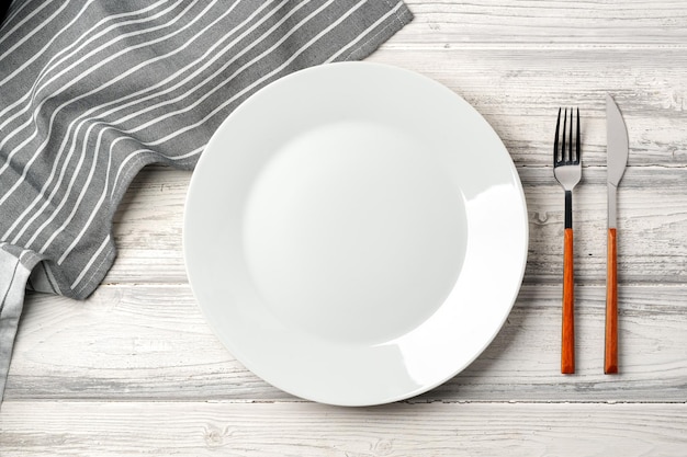 empty plate with fork and knife on table