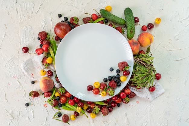 Empty plate with raw vegan food laying around it