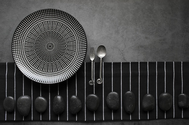 Empty plate with silver cutlery on the black background close up Restaurant menu concept template design Top view Copy space