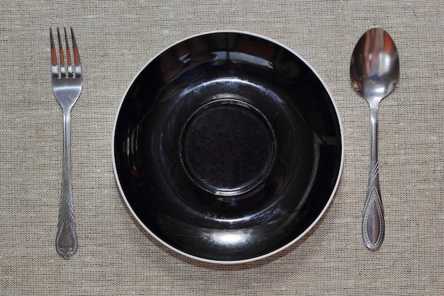 Empty plate with spoon and fork