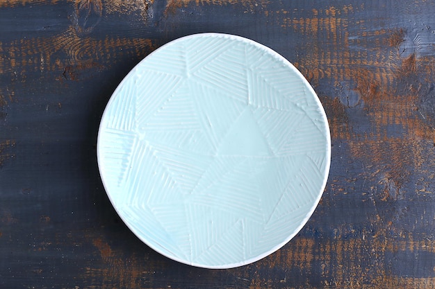Empty plate on wooden background top view