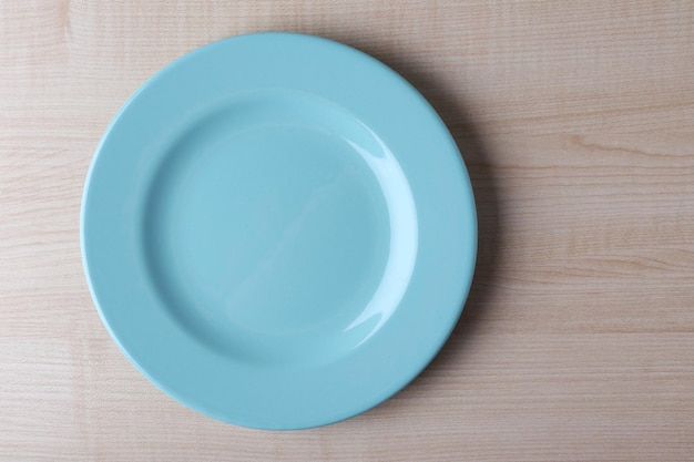 Empty plate on wooden background