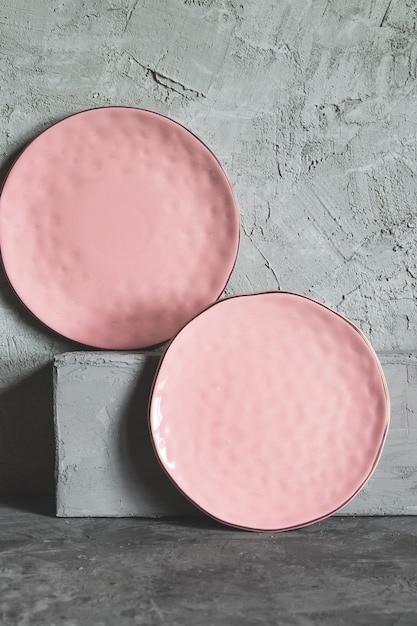 Empty plates (ceramic) on a gray stone background. Gray minimalism concept