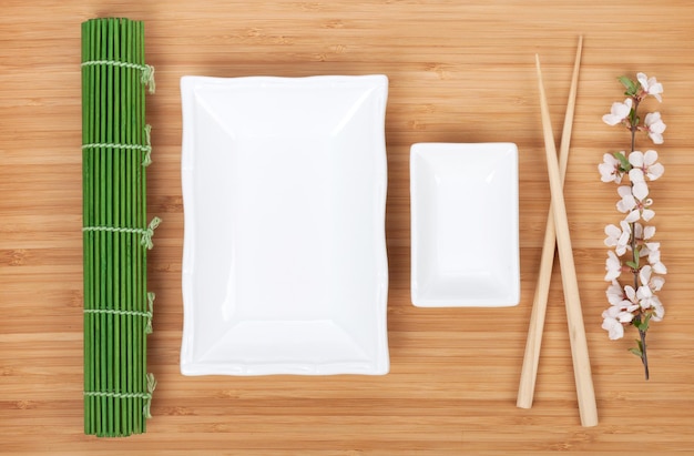 Empty plates chopsticks and sakura branch