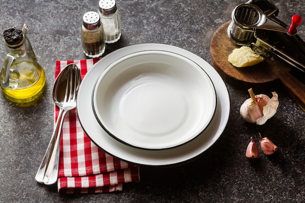 Empty plates on the table set for lunch or dinner.