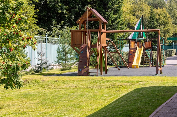 Photo empty playground for children for leisure and recreation with a toy in the park as a child in a natural style. playground in a swing for mom and baby