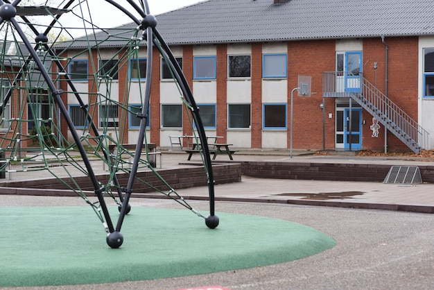 An empty playground in a schoolyard on a rainy day