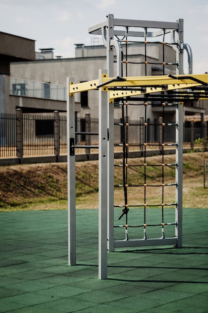 Empty playground with horizontal bars, crossbeams and parallel bars. Outdoor sports in nature in the city green park.