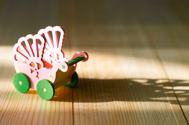 Empty pram on a wooden background