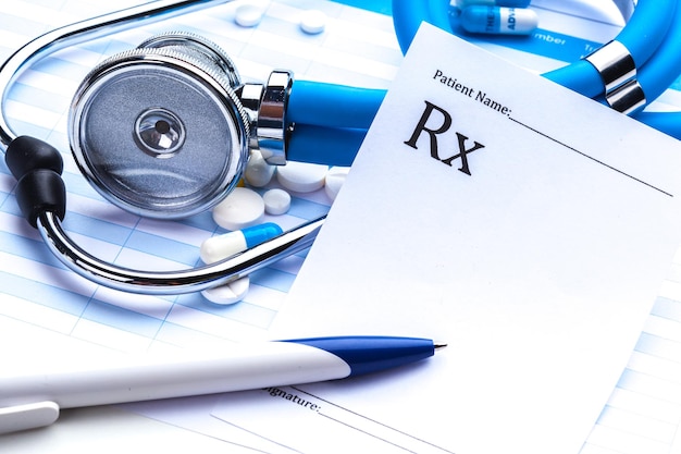 Empty prescription lying on table with stethoscope