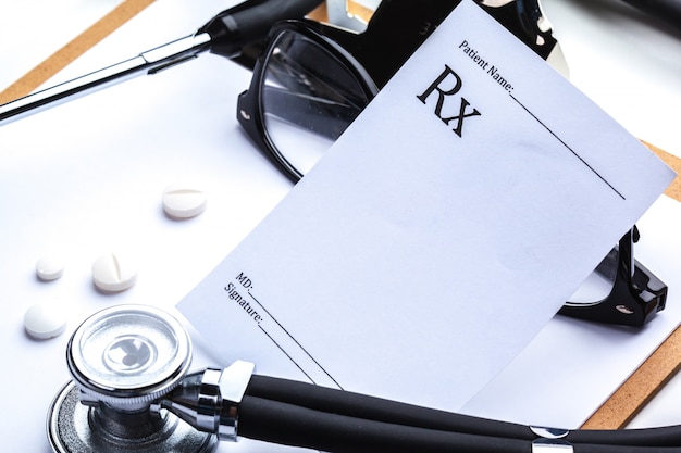 Empty prescription  lying on table with stethoscope