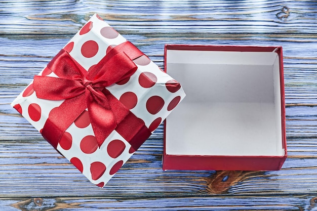 Empty present box with bow on vintage wooden board