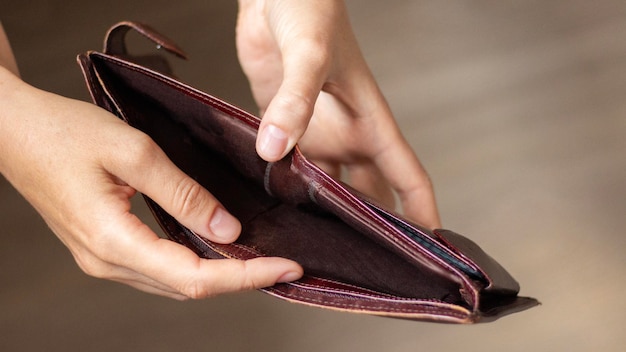 Empty purse in the hands of a young woman