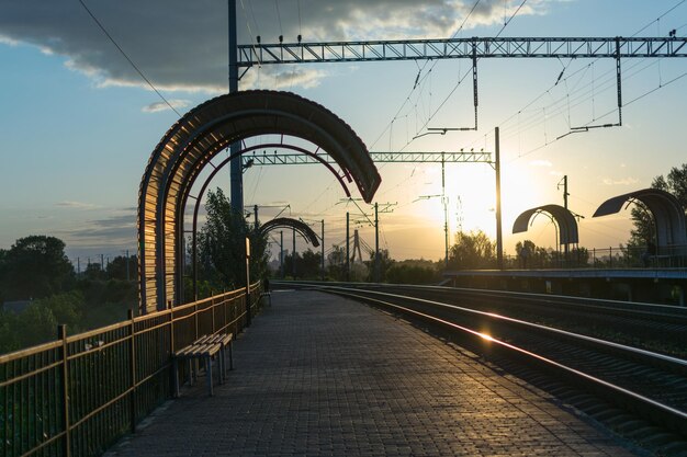 An empty railway platform in the evening at sunset