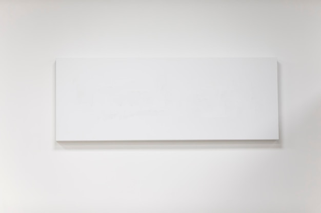 Empty rectangular picture frame on a gray wall