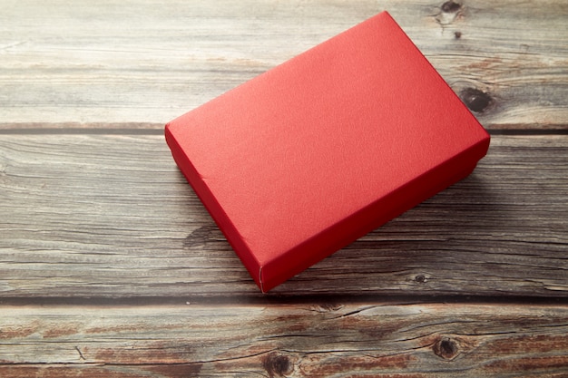 Empty red box on bright brown wood