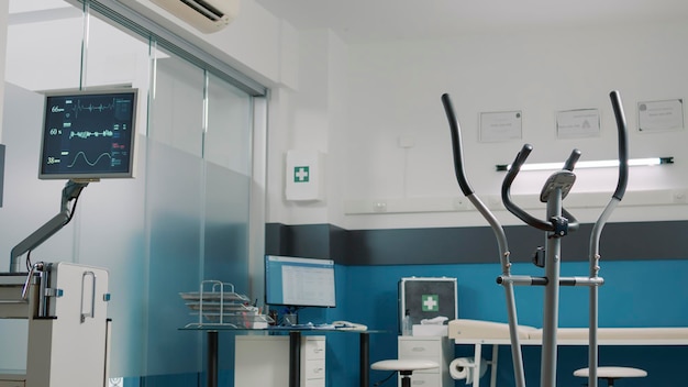 Empty rehabilitation cabinet to help with physiotherapy, using\
stationary bicycle to increase mobility and heart rate monitor to\
measure pulse. alternative medicine to cure mechanical\
disorders.