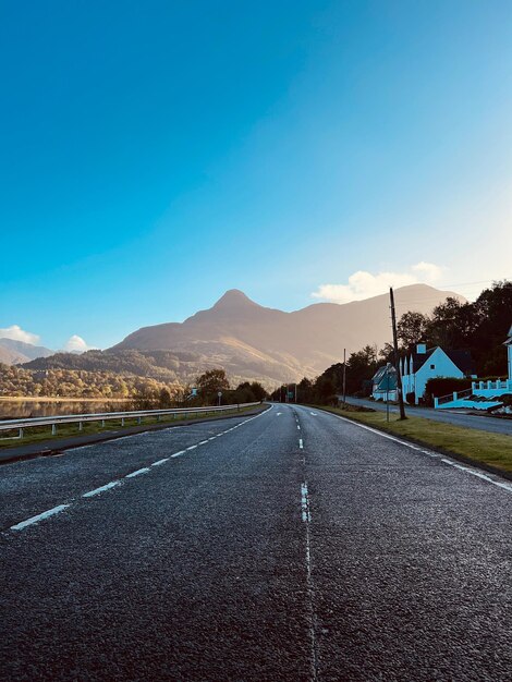 Empty road against mountains