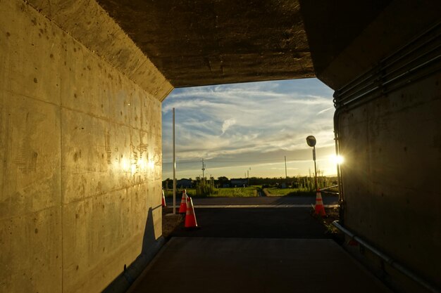 Empty road against sky during sunset