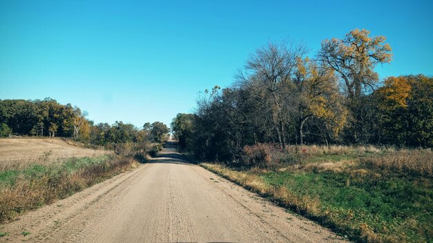 Empty road along countryside landscape