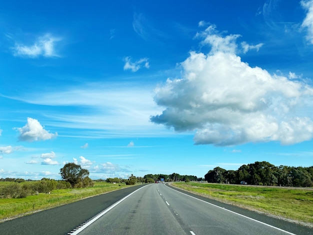 Empty road along countryside landscape